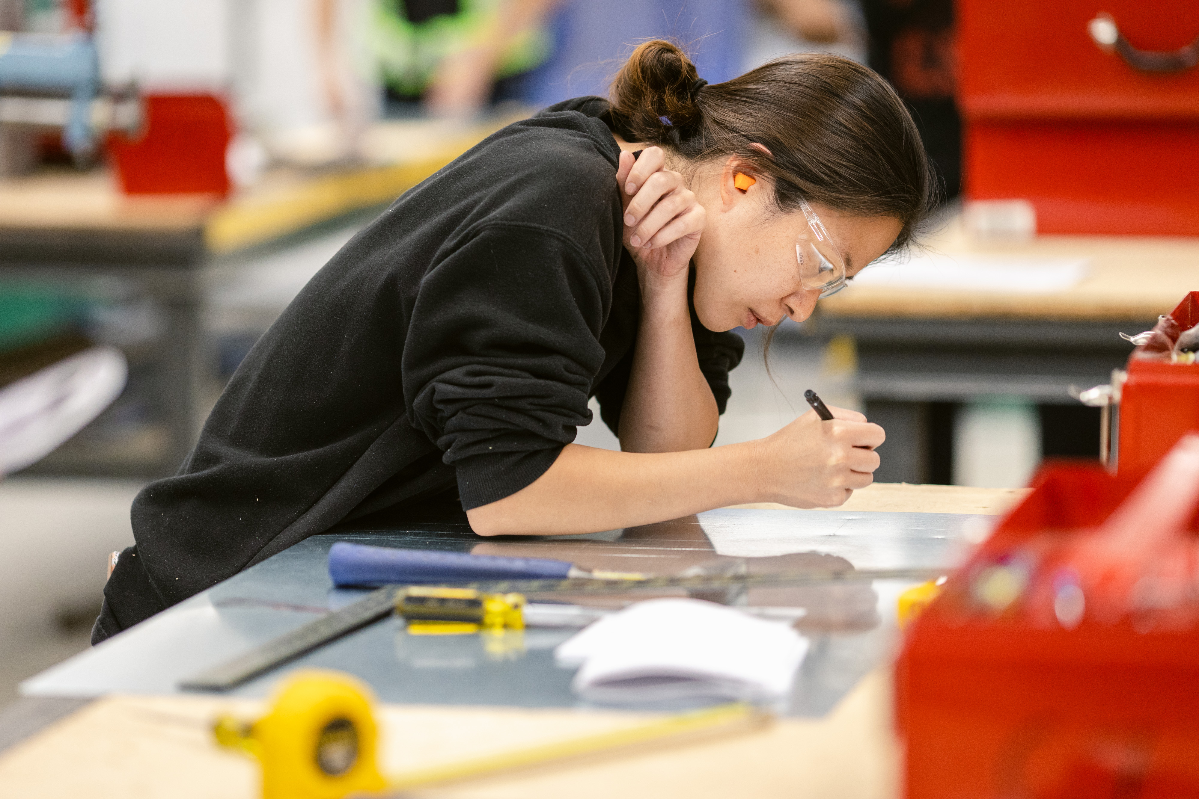 woman intently working at a desk